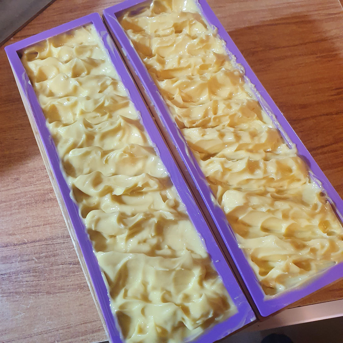 Two loaves of soap in purple molds