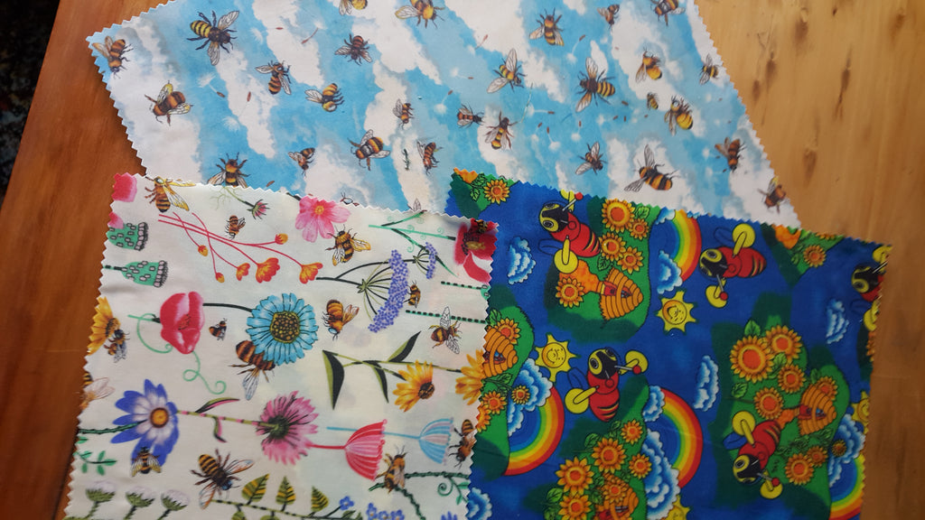 Colorful fabric samples with various patterns on a wooden surface