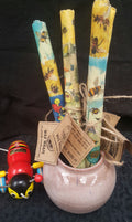 three rolls of bees wax wraps in a jar with a wooden bee